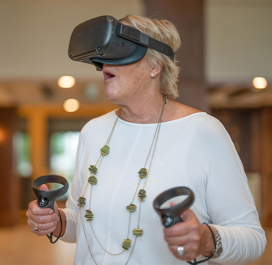 Elderly woman with virtual reality goggles and controls Elderly woman with virtual reality goggles and controls