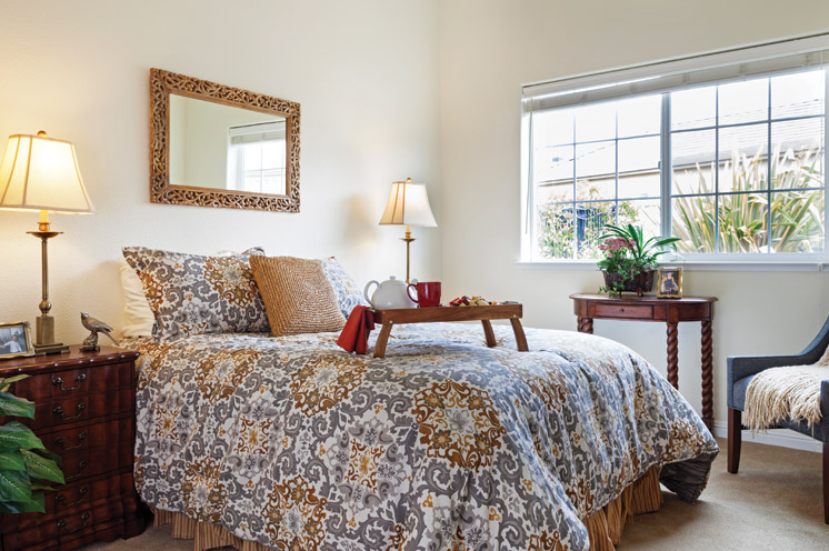 An elegant bedroom with a breakfast tray on the bed
