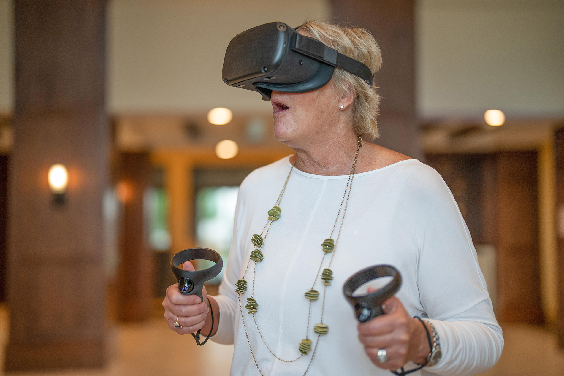 Elderly woman with virtual reality goggles and controls Elderly woman with virtual reality goggles and controls