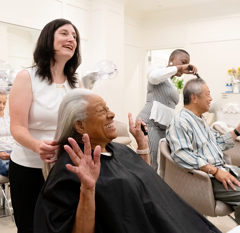 Indulge An elderly woman and gentlemen enjoy salon services at Indulge Salon and Spa, an on-site service Watermark Community