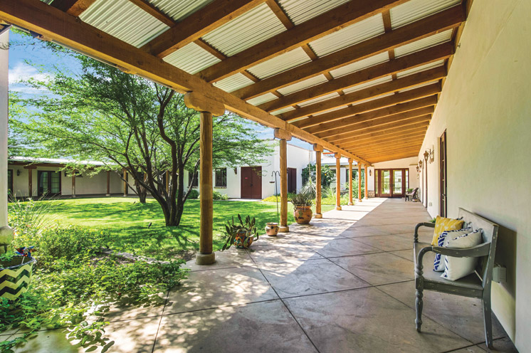 A covered walked way surrounding an outdoor courtyard at The Hacienda at the Rivers