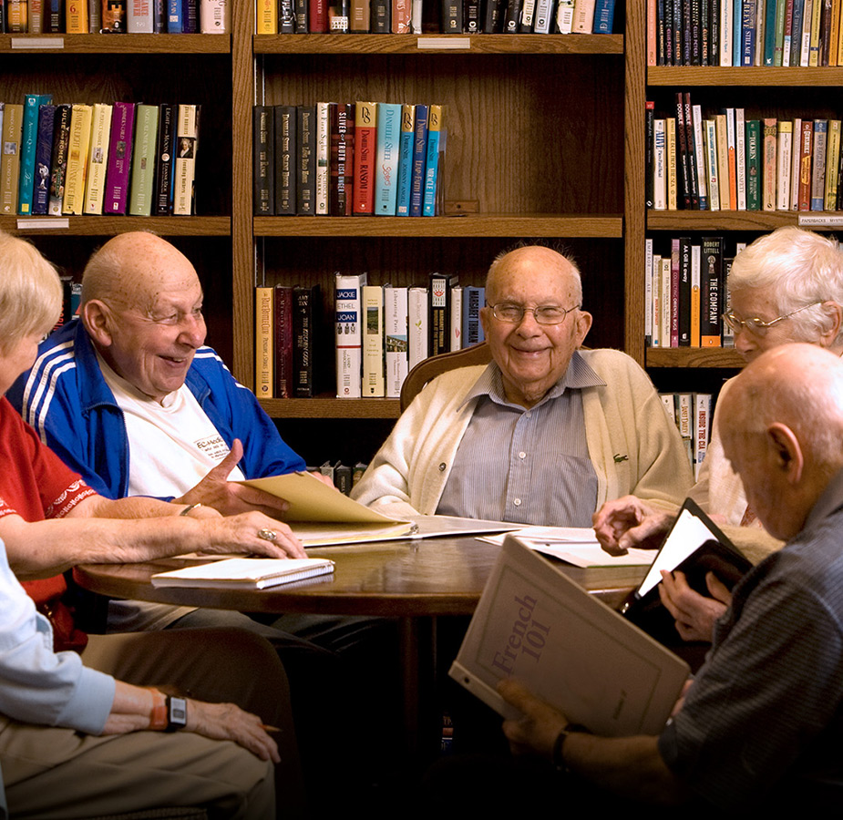 A group of seniors partaking in a painting workshop with an instructor A group of seniors partaking in a painting workshop with an instructor
