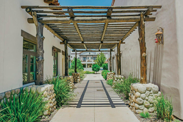 An outdoor pathway covered by a wooden terrace at The Hacienda at the Rivers
