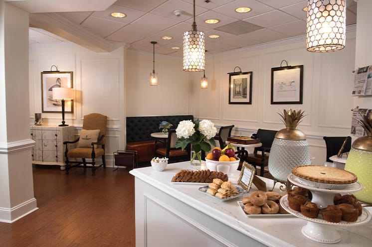 A counter with a variety of fresh pastries made but in-house chefs for residents to enjoy with coffee or tea every morning