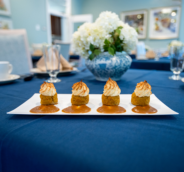 Desserts presented on a plate set on a table with a blue table cloth Desserts presented on a plate set on a table with a blue table cloth