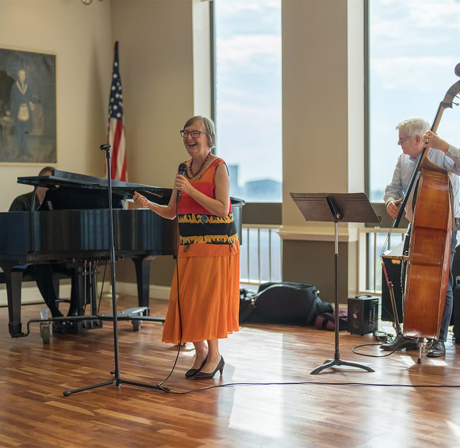 trio of seniors singing and playing instruments
