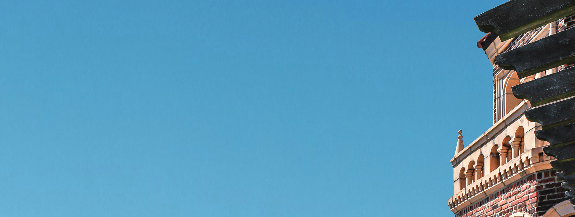 blue sky and portion of a brick tower