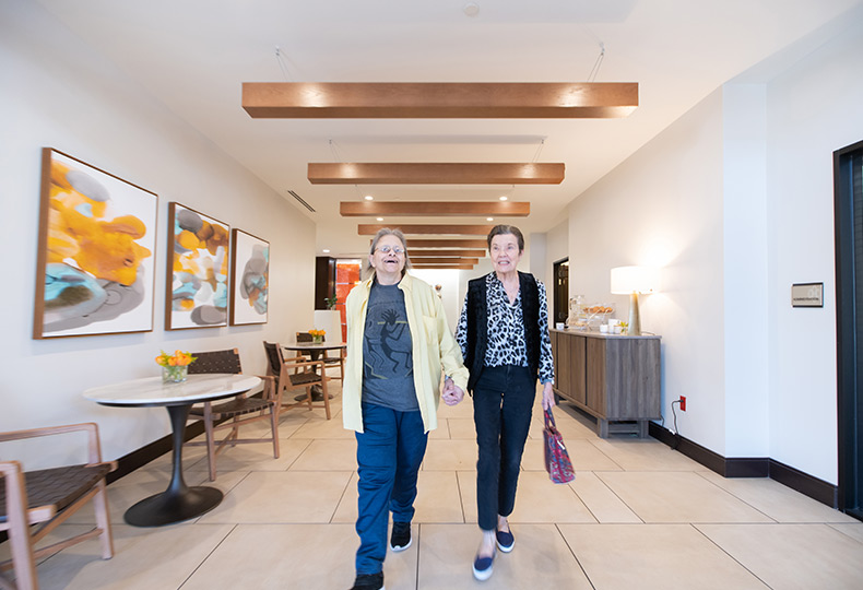two residents strolling down the hallway