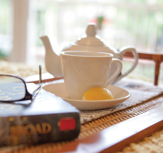 Cafe A welcoming tea pot with a book beside it