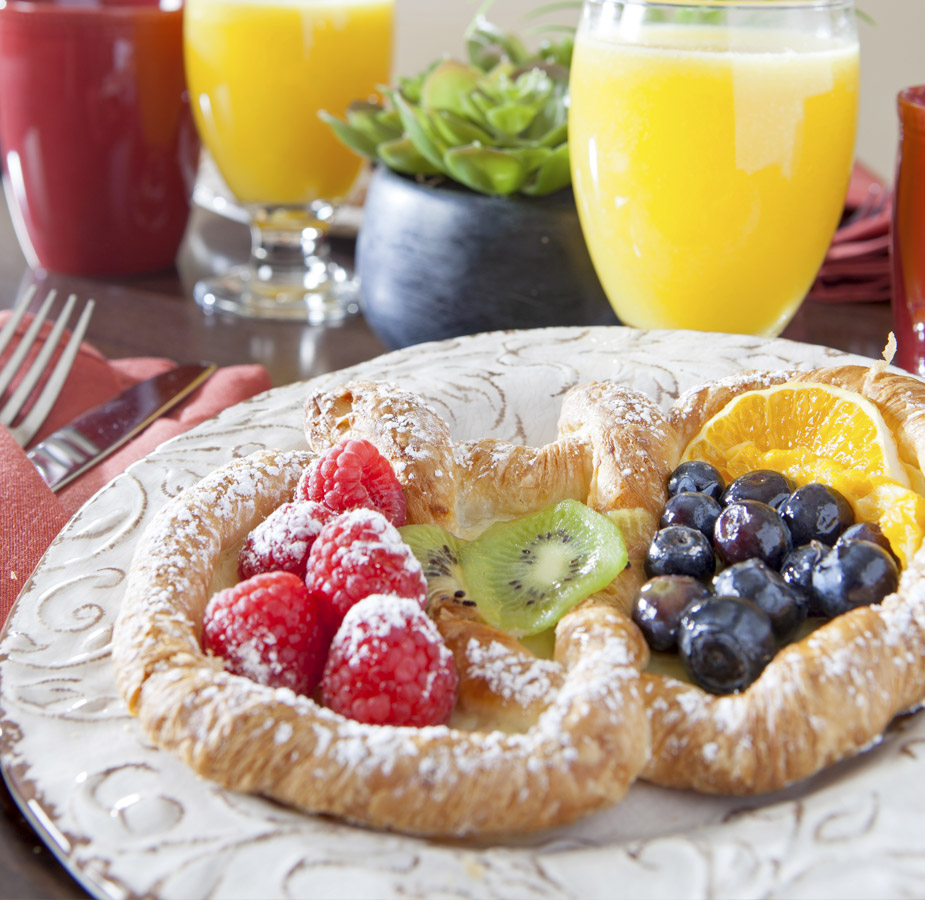 Dining A welcoming breakfast made of fruit pastry and orange juice in champagne glasses