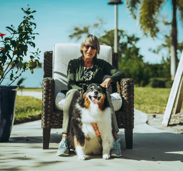 Dog Park Sitting lady with her dog outside on a sunny day