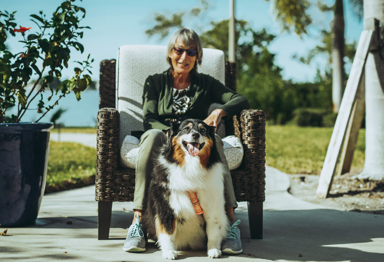 Dog park Sitting lady with her dog outside on a sunny day