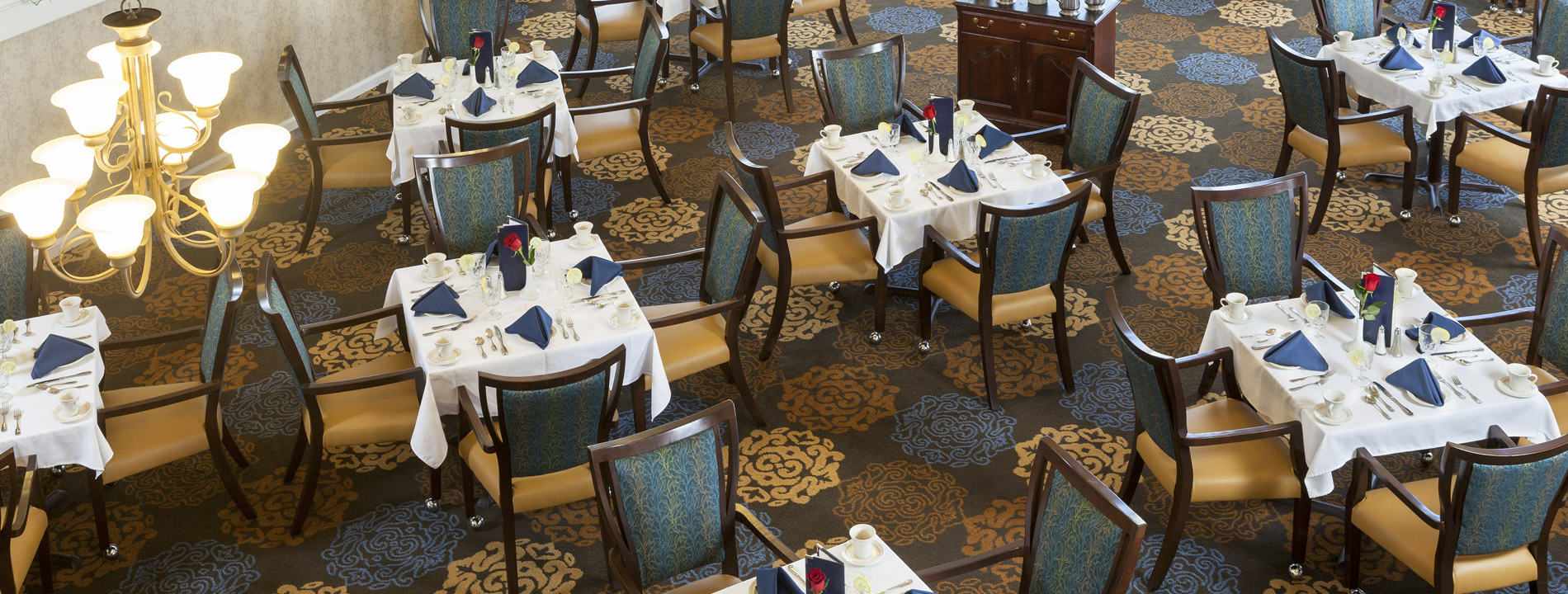 Dining area with multiple table setup with silverware