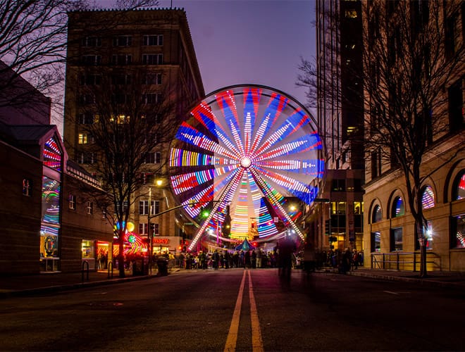 The Fountains at the Albemarle Partnerships A ferris wheel lit up in downtown Raleigh NC on New Years Eve