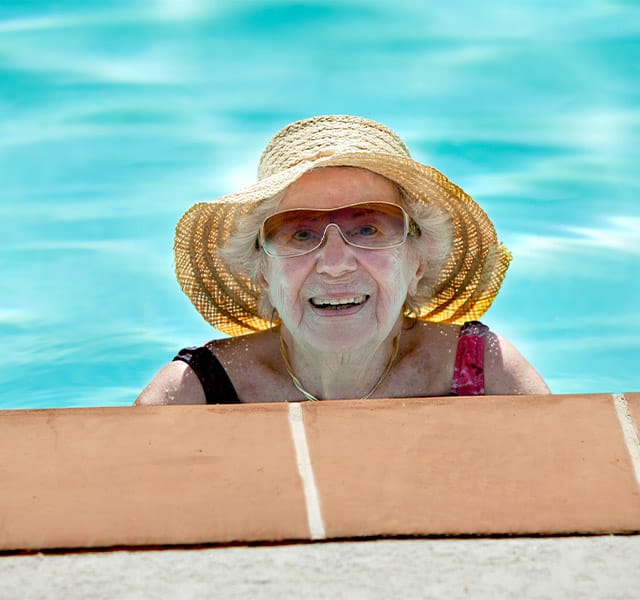 A resident enjoying the outdoor pool