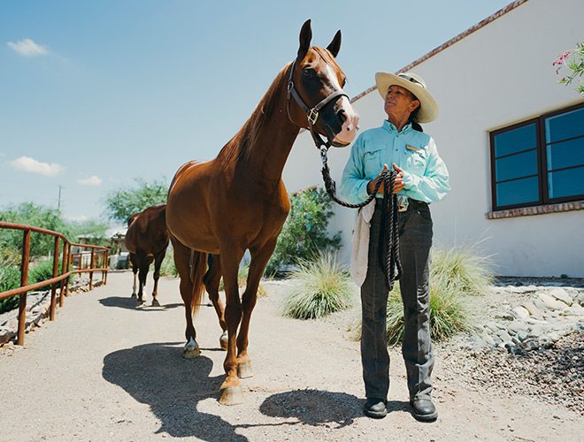 The Hacienda at the River A resident and a horse at the stables at The Hacienda at the River