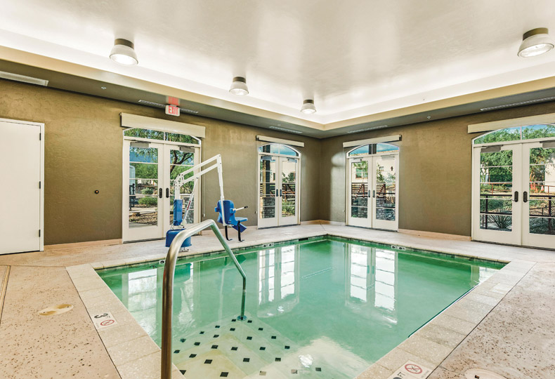The Hacienda at the River An indoor pool with chair that can be raised and lowered into the pool for individuals with mobility issues at The Hacienda at the River
