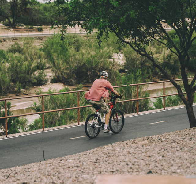 The Hacienda at the Rivers A resident enjoying an outdoor bike ride on an outdoor pathway in Tucson, AZ