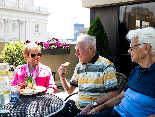 The Preston at the Park Cities Flex Spending A group of seniors enjoying lunch on a patio