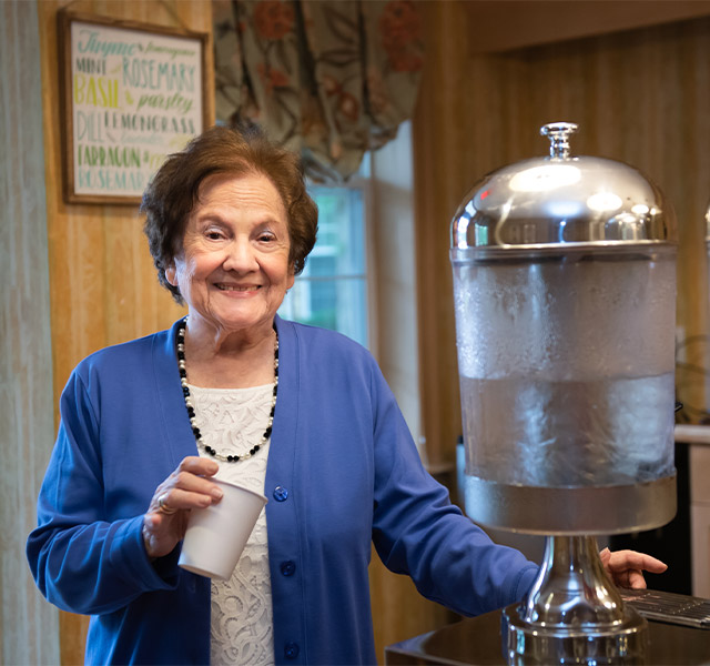 The Preston of the Park Cities What They're Saying A resident standing at a water cooler smiling into the camera