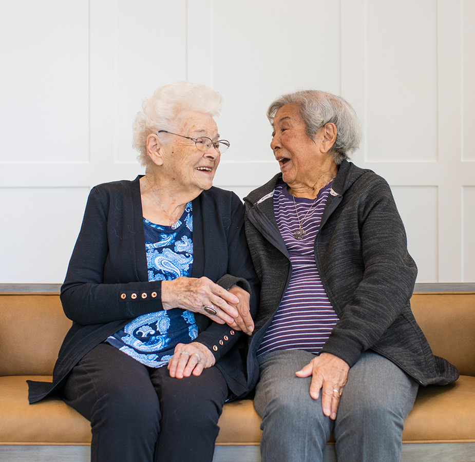 Residents sitting on a couch Two residents enjoying each other's company