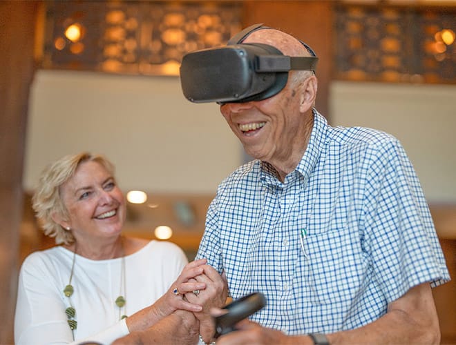 Elderly couple enjoying EngageVR programming offered at select Watermark Properties