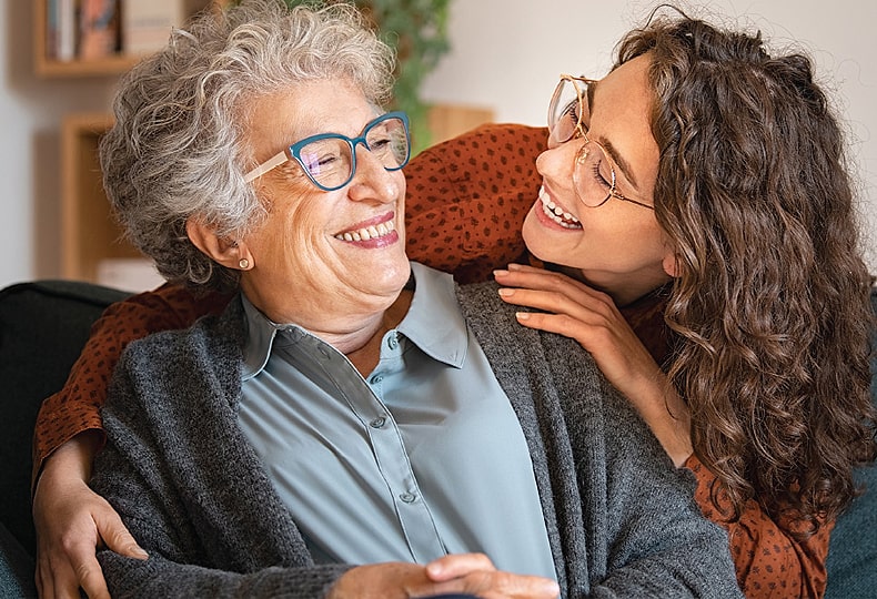 Elder and Younger women smile each other