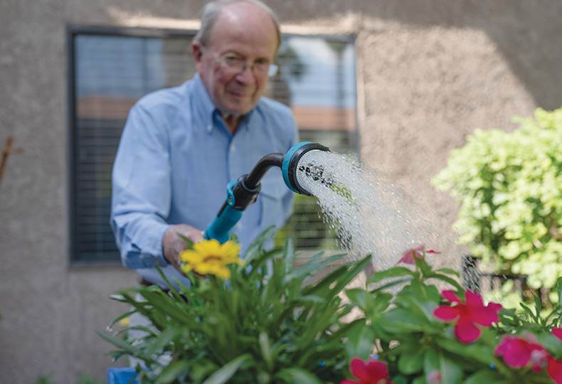 A grandfather watering the flowers