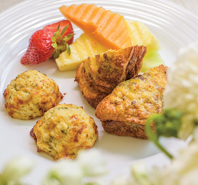 Watermark Retirement Communities Gourmet Bites Cuisine A chef holding a plated meal